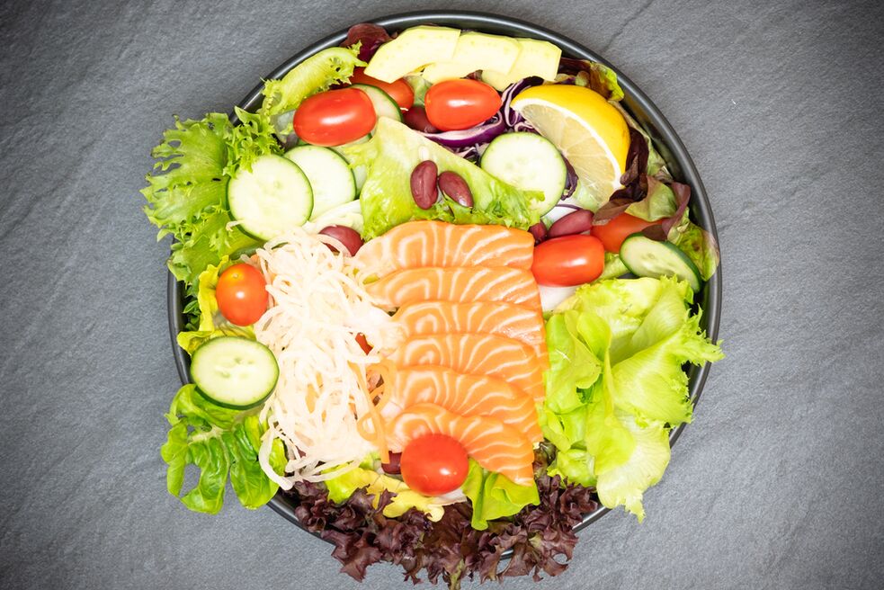 A delicious salad with salmon on the menu of a proper diet for weight loss